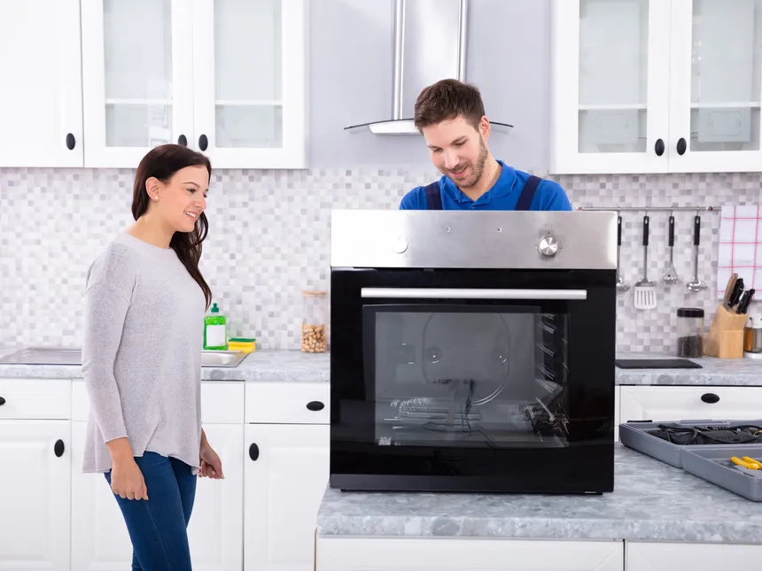 Technician And Customer Beside An Electric Oven