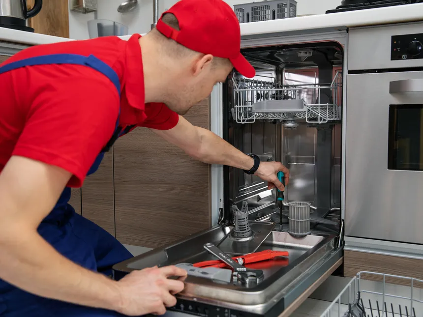 Technician Inspecting An Open Dishwasher