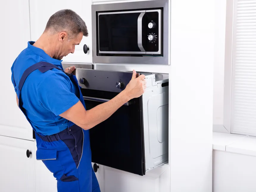 Technician Inspecting An Electric Oven